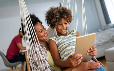 Portrait of happy mother with child using digital tablet for education, fun, game. Technology people