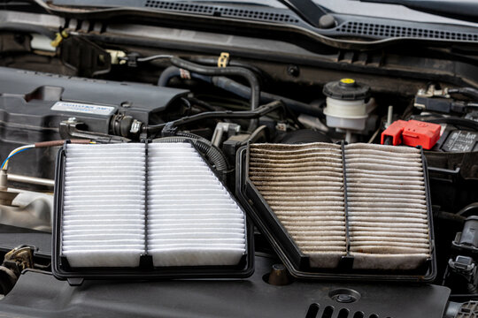 New and old, dirty air filter side by side on vehicle engine. Automotive repair, maintenance, service and fuel mileage concept