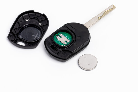 Car key FOB remote with battery. Vehicle keyless entry, automotive repair and maintenance concept.