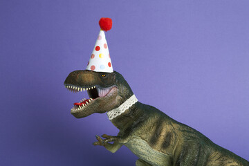 violet a dinosaur, dressed up in lace and a paper party hat