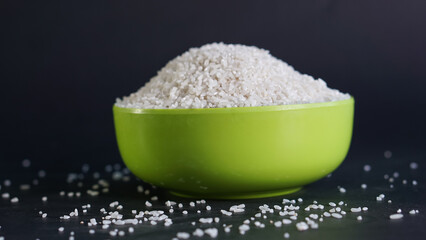 Rice in bowl with black background, with copy space