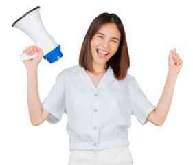 Beautiful Asian woman holding megaphone and shout with fists clenched celebrating victory expressing success on yellow background.