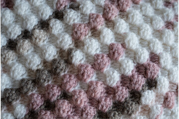 Pink and white crocheted blanket up close