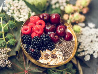 Breakfast bowl with berries and granola on table