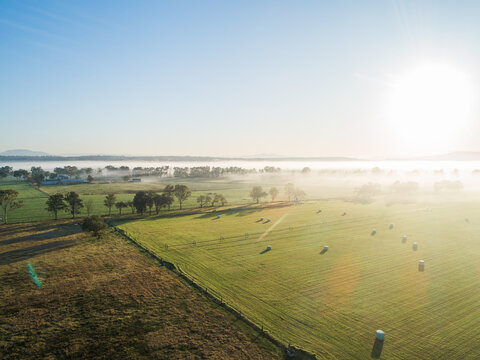 Farmland fields and sunrise sunshine with mist on the horizon