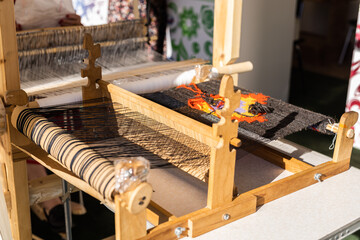 Handloom with wooden shuttle with mottled thread and bobbins of yarn - craft and handmade...