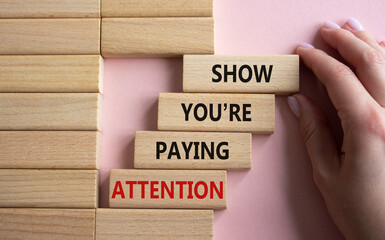 Attention symbol. Concept word Show You are Paying Attention on wooden blocks. Beautiful pink background. Businessman hand. Business and Show You are Paying Attention concept. Copy space