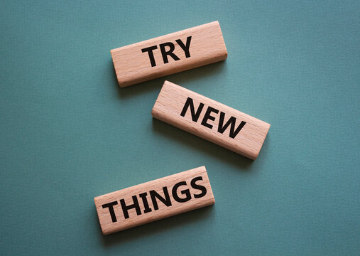 Try new Things symbol. Concept words Try new Things on wooden blocks. Beautiful grey green background. Business and Try new Things concept. Copy space.