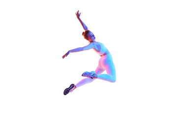 Fitness portrait of young woman dressed sportively doing jumps in motion isolated white background in neon light.