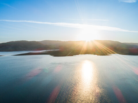 Sunset over lake water from drone perspective