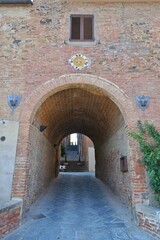 Fototapeta na wymiar An ancient entrance arch in Torrita di Siena, a medieval town in Tuscany.