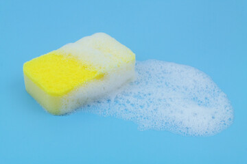 Sponge with white foam on blue background.