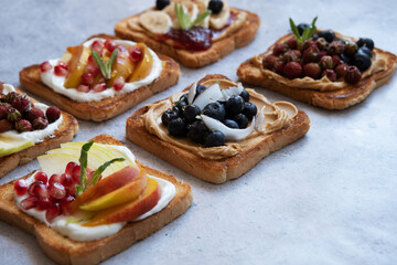 Sweet toasts made from fresh berries, jam, peanut butter and honey. Healthy toasts made from berries and fruits