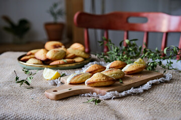 Freshly baked madeleine cake. Madeleines with glaze. French sponge biscuits - obrazy, fototapety, plakaty