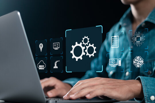 Robotic process automation technology being setup by expert working on laptop computer. Automation software, business and industrial workflow optimization. Automate software system business concept.