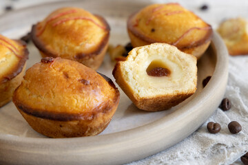 Pasticciotto leccese pastry filled with egg custard cream and sour cherry jam on a plate close up