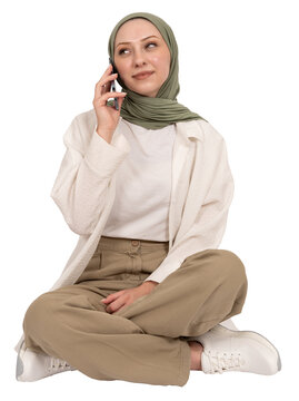 Woman talking on the phone, full length body view young caucasian muslim woman talking on the phone. Sit floor calling friend or family, smiling, listening. Online communication concept idea image. 