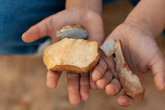 Close up of chipped cutting stones in aboriginal boy's hands
