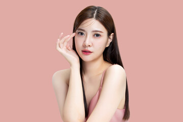 Portrait beauty Asian woman with K-beauty make up showing fresh and clean skin isolated on pink...