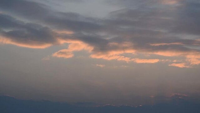 Clouds forming during sunset in time lapse