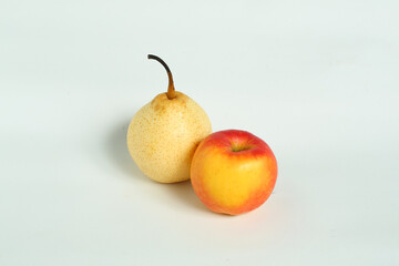 pear and red apple placed on a plain white base