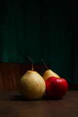 red pears and apples on a wooden base