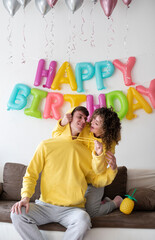 Fototapeta na wymiar young happy couple celebrating birthday at home