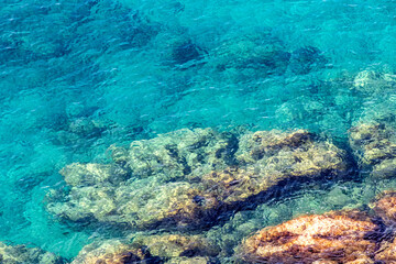 Rochers ocres recouverts d'une eau cristalline dans la mer méditerranée à Nice sur la Côte d'Azur