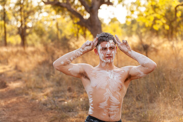 Young first nations Australian man performing aboriginals dance about kangaroos on country