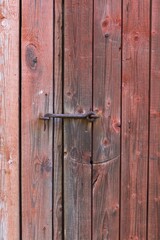 Old wooden door and metal hook.