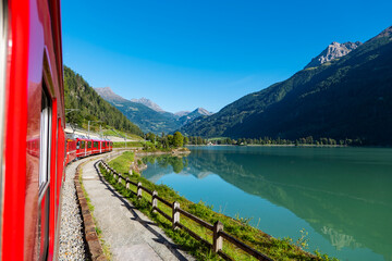 Red train of Bernina in the Swiss alps - 653778773