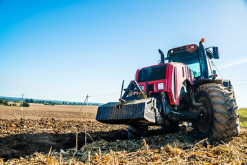 Tractor in the field. Agricultural machinery. Agricultural farm tractor during tillage of soil and...