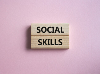 Social skills symbol. Wooden blocks with words Social skills Beautiful pink background. Business and Social skills concept. Copy space.