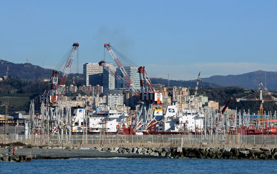 The industrial and maritime area of ​​the port of the Italian city of Genoa. In the picture, the cranes of the Fincantieri shipyards and tankers in the oil port.