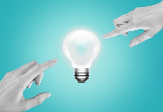 Hand reaching to light bulb. Energy concepts
