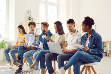 Business people sitting in row studying on seminar training, making tasks together using laptops. Working and educational brainstorming process in international company. Adult education concept.