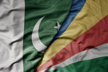 big waving realistic national colorful flag of pakistan and national flag of seychelles .