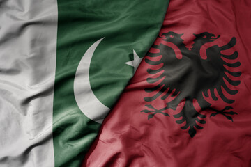 big waving realistic national colorful flag of pakistan and national flag of albania .
