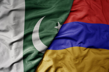 big waving realistic national colorful flag of pakistan and national flag of armenia .