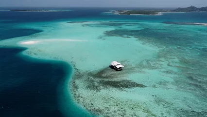 Foto op Canvas Caribbean scenery. Pannning wide landscape of stunning island with turquoise water. Caribbean sea. Travel destination. Los Roques Caracas Venezuela. © ByDroneVideos