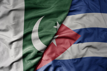 big waving realistic national colorful flag of pakistan and national flag of cuba .