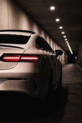 vertical white car in a hallway graded