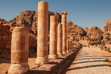 Petra is ancient capital of Nabataean kingdom in Jordan. Road with preserved columns to rock monasteries. Ancient religious center of Petra.
