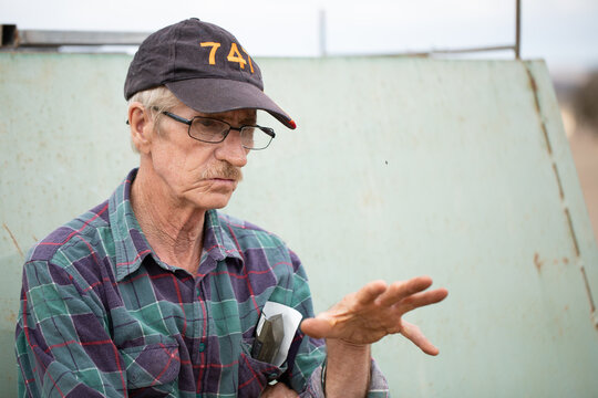 old bloke using hand gestures while talking