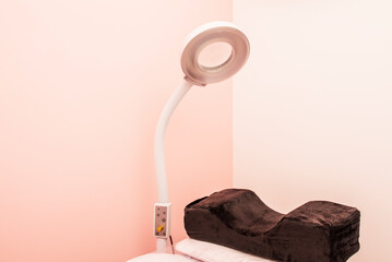 A white circular lamp for skin treatment in a beauty clinic