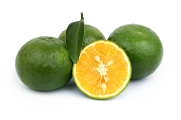 Green oranges with leaf isolated on white background.