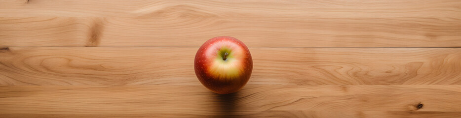 Vista superior de una mesa de madera con una manzana en medio. Banner horizontal de alimentos para...