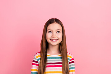 Photo of cheerful little cute girl brown hair looking interesting interactive games app funny kid isolated on pink color background