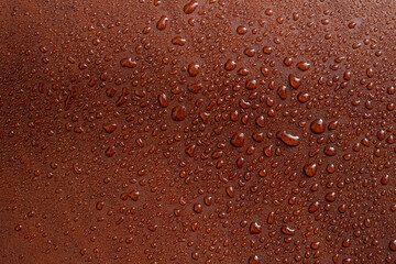 water drops on red brown leather texture, soft focus close up