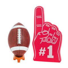 An American football with white strip used for college and high school football games on a orange kicking tee along with a red foam 1 finger. © CMANNPHOTO